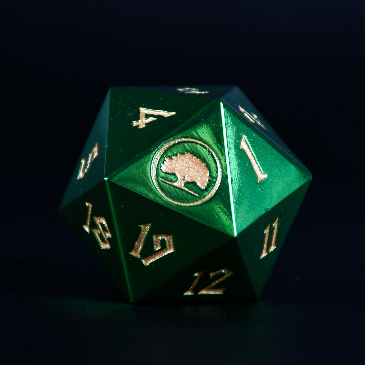 Green polyhedral dice with gold numbers and a logo on a dark background