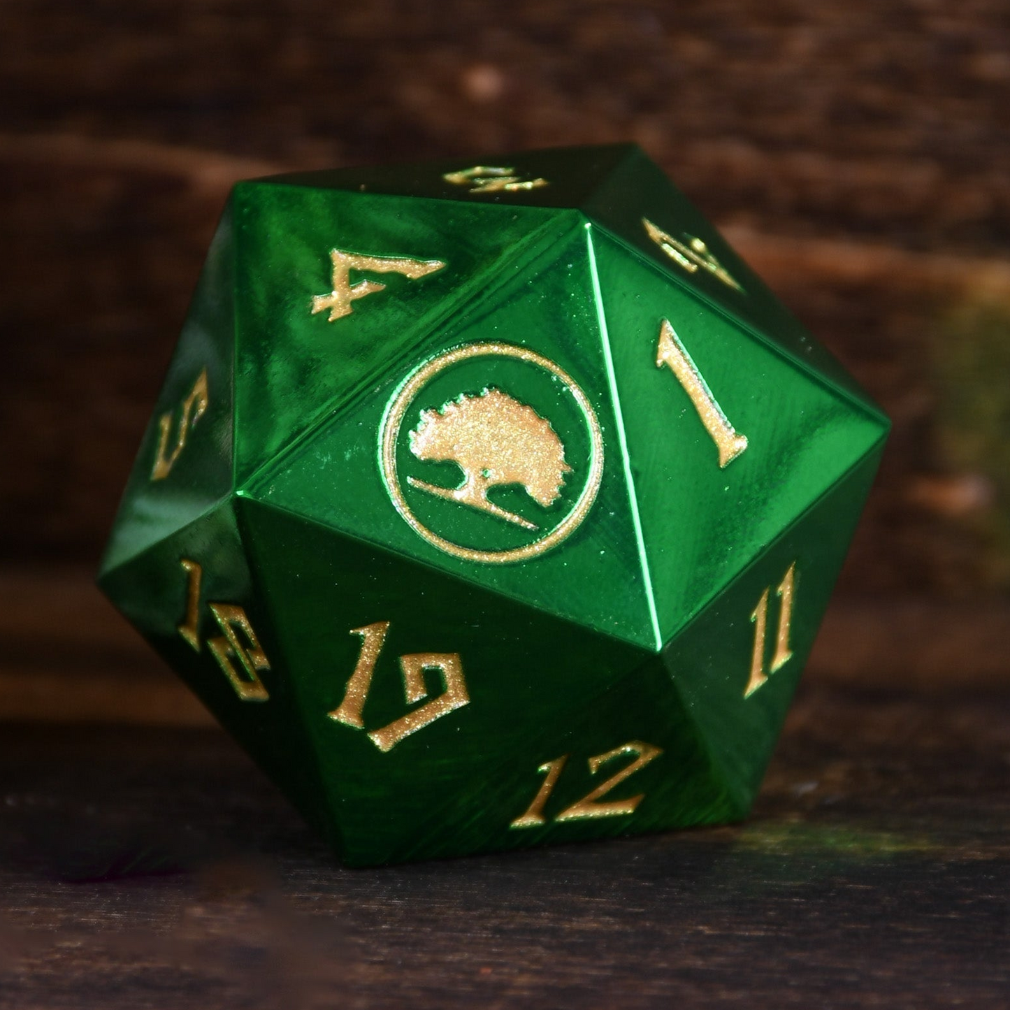 Green polyhedral dice with gold numbers and a logo on a dark background